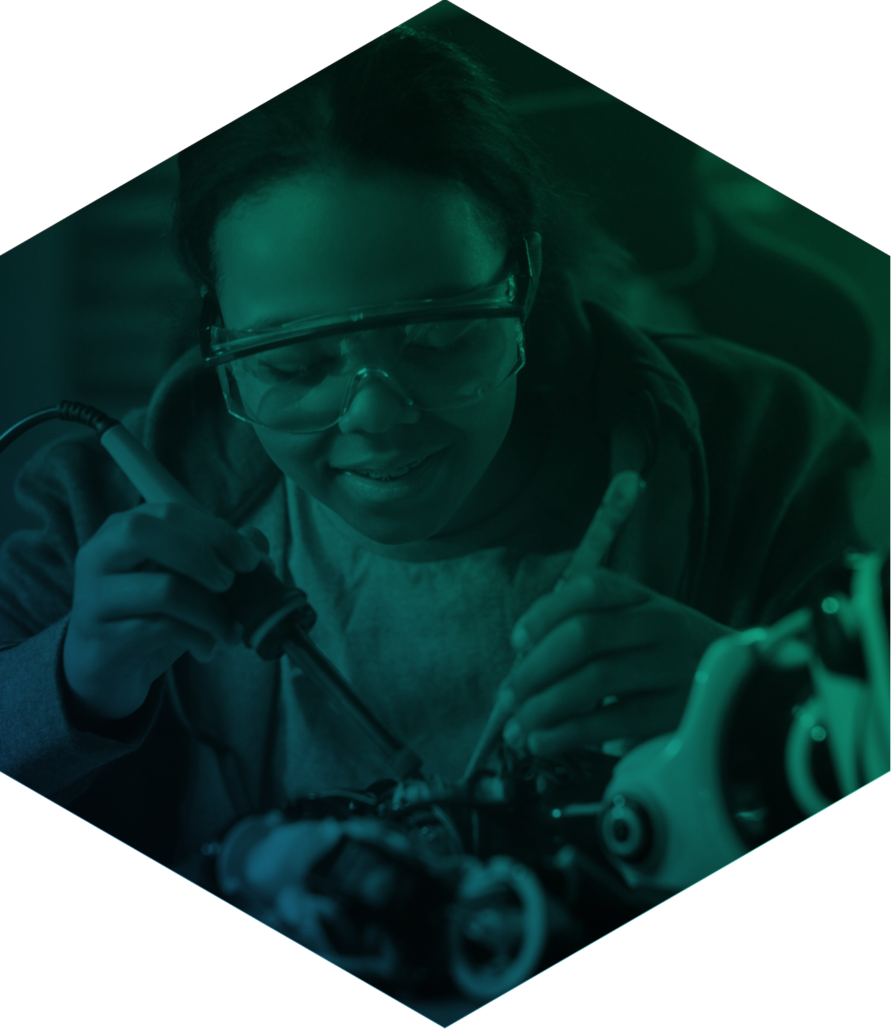 Student soldering with safety glasses on seen through green filter